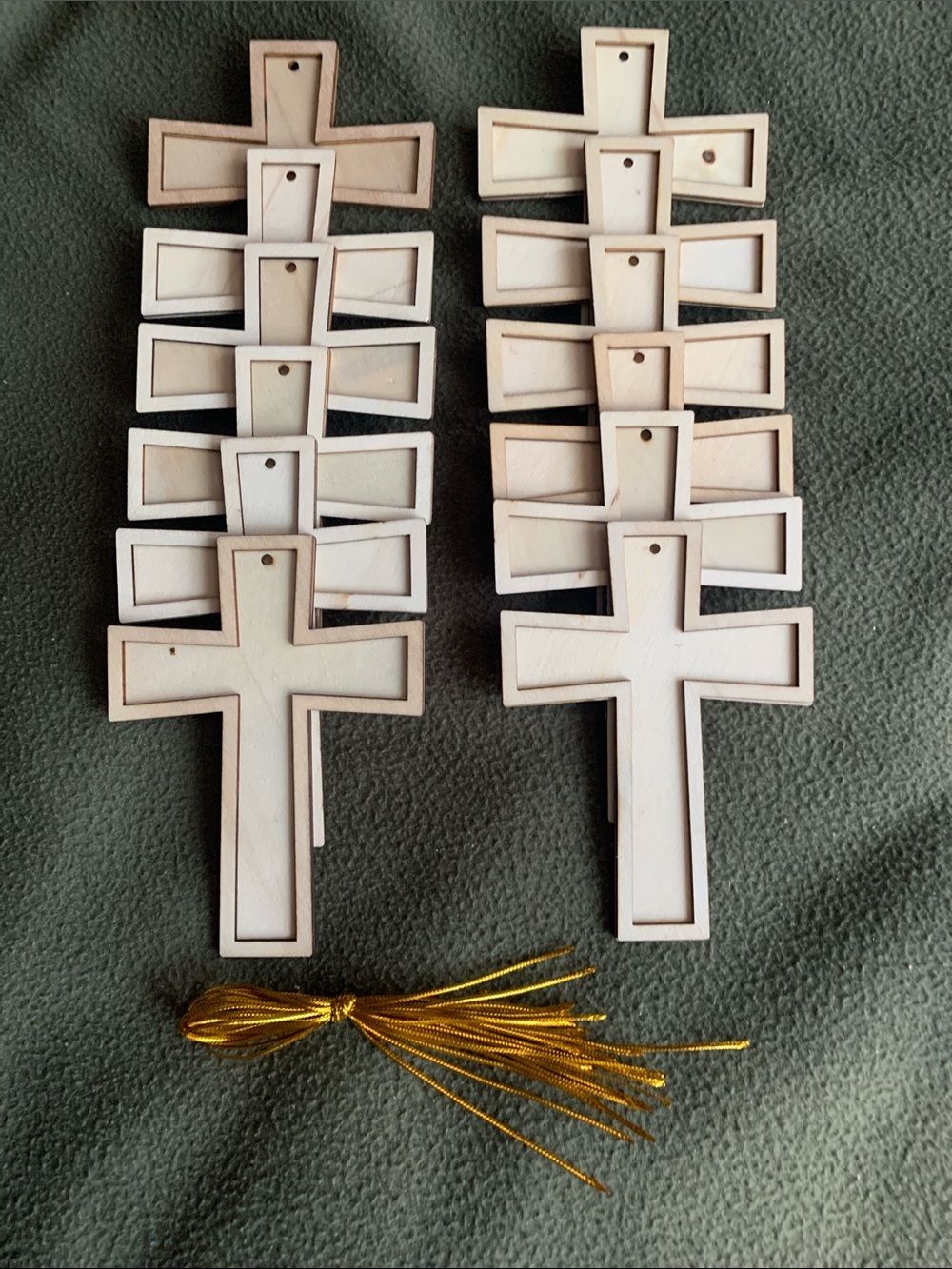 12 layered unfinished wooden crosses w/ holes and gold string. 3.75โ x 5โ